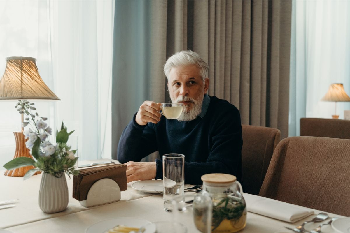 A photo of a man having tea.