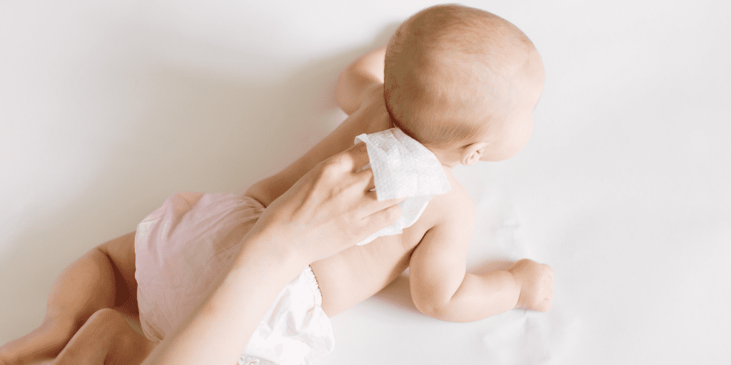 A photo of a mother wiping her baby with Costco baby wipes