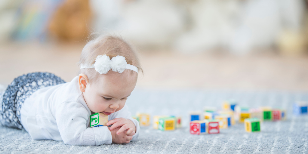 A photo of a little girl playing with cubes.