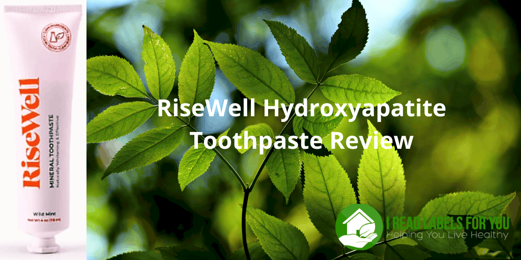 RiseWell Hydroxyapatite Toothpaste Review. A photo of Risewell toothpaste tube with green leaves in the background.