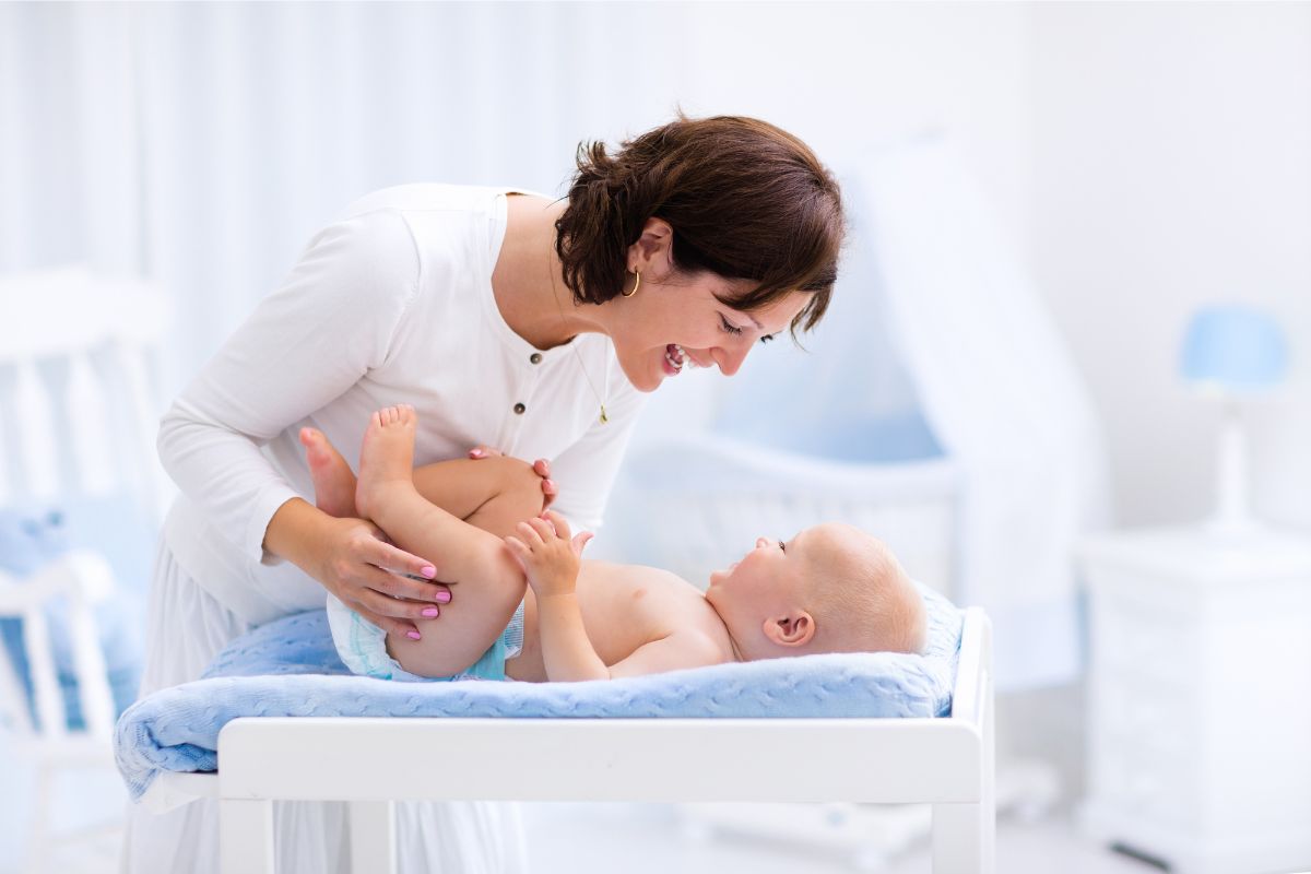 woman with her baby for opinion about materials in the best Non-toxic changing pad.