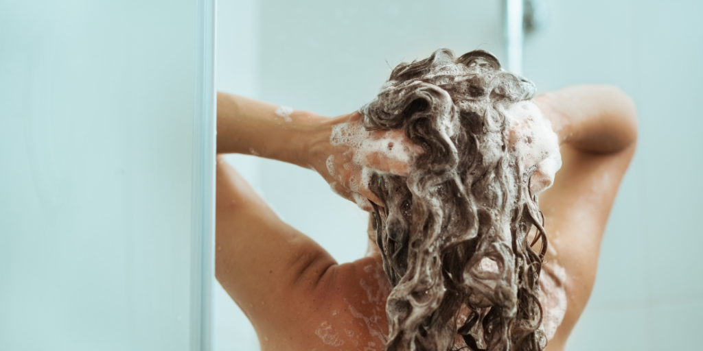 a woman washing her hair.