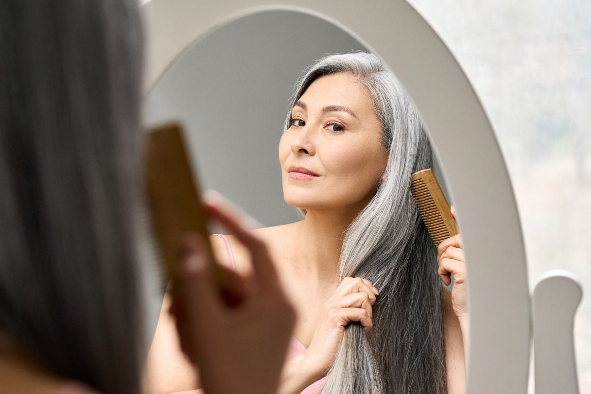 A photo of a woman with long grey hair.