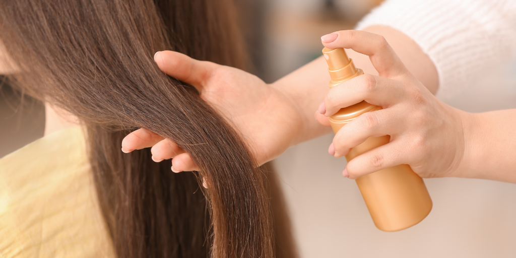 A photo of a woman using a hair conditioner with cyclopentasiloxane.