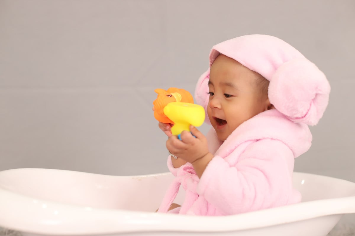 Tear-free baby shampoo options I Read Labels For You answer to the question How To Tell If A Shampoo Is Gentle Without A Tear-Free Label. Image of a baby in a tub wrapped in a bath towel.