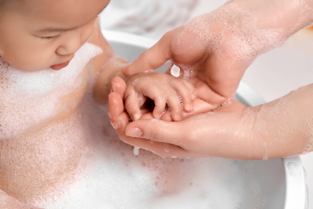 I Read Labels For You answer to the question What Does Tear-Free Mean on Baby Shampoo. Image of a baby taking a bath with tear-free shampoo.