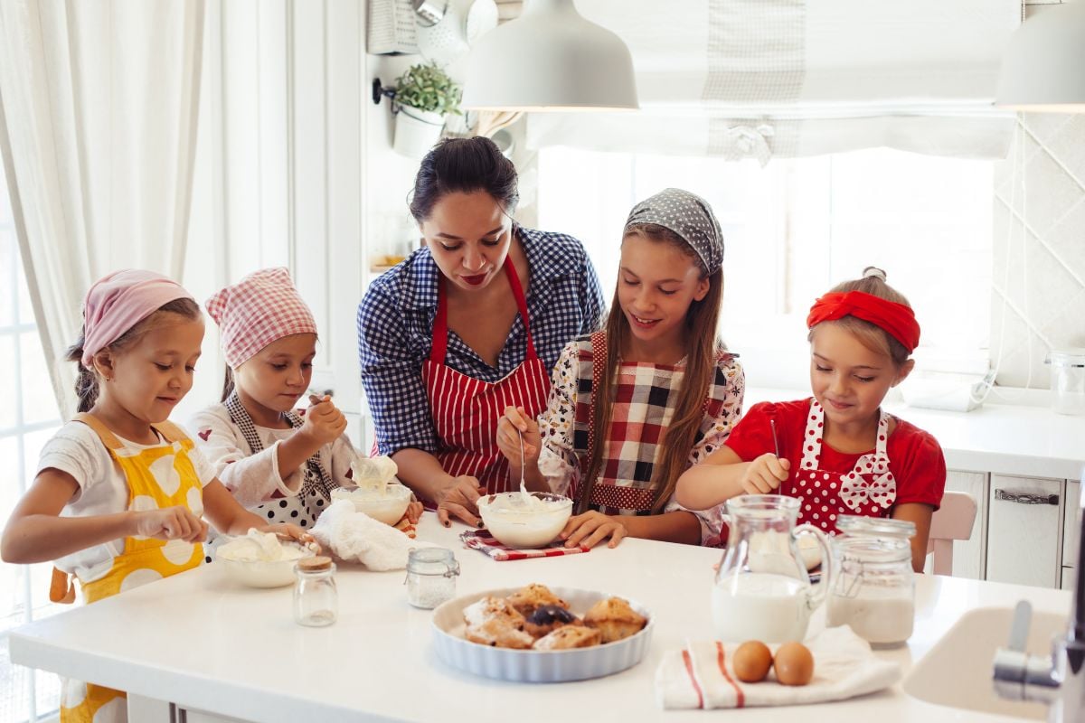 A photo of girls making dessert potentially using Thermolon cookware.