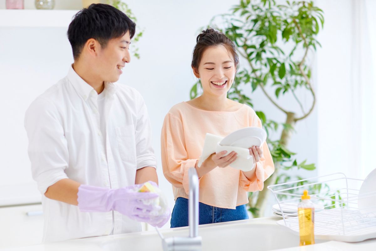 Young couple washing the dishes using the ECOS Dishwashing Liquid.