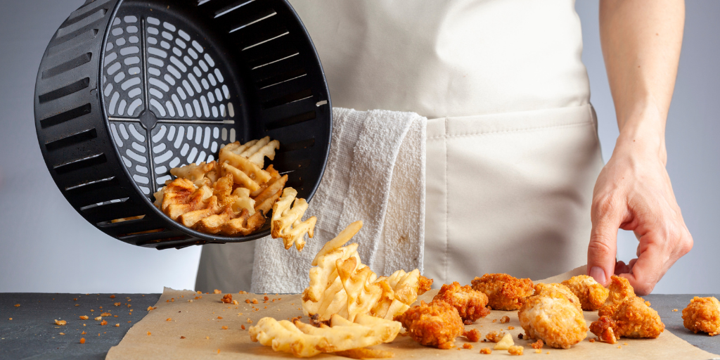 A photo of fried potatoes and chicken