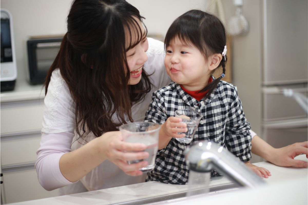 Mom and daughter drinking water