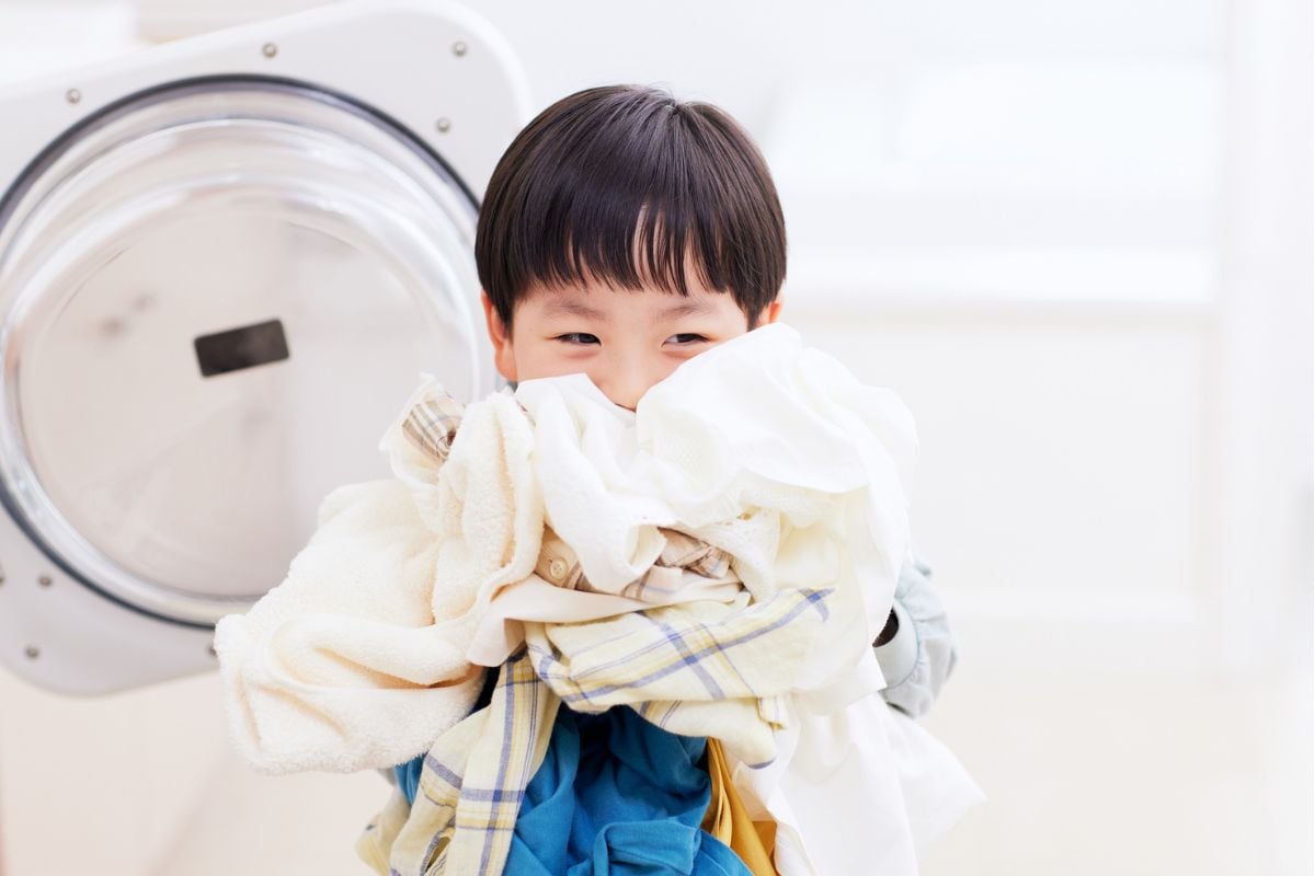 A child holding laundry.